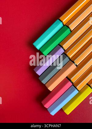 Colorful markers for office and study. Many colorful markers on a colored background, flat lay. School stationery. The concept of study, office. Stock Photo