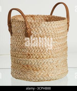 Tall round woven basket made from natural fibers isolated nature background with clipping path Stock Photo