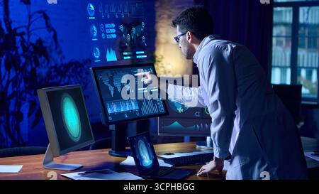 Futuristic scientist standing at interactive holographic dashboard analyzing AI data. Collage Stock Photo