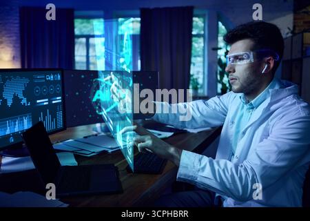 Scientist wearing AR glasses interacting with futuristic AI interface and digital dashboards. Collage Stock Photo