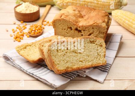 Freshly baked cornbread, cobs and seeds on wooden table, closeup Stock Photo