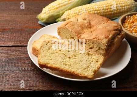 Freshly baked cornbread, cobs and seeds on wooden table, closeup Stock Photo