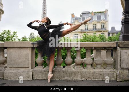 Ballet dancer posing on Paris terrace with Eiffel Tower view Stock Photo