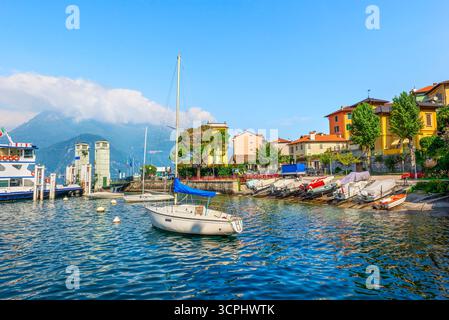 Boats and ferry in Varena moored in port on lake Como, Italy Stock Photo