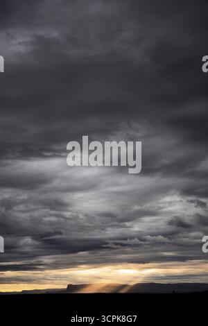 Dark clouds and sun beams Stock Photo