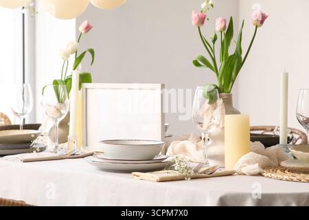 Elegant table setting with beautiful tulip flowers in restaurant Stock Photo