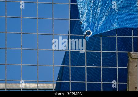 close up of a metal fence with abstract blue background in the garden Stock Photo