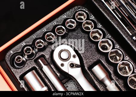 Toolbox with metal ratchet and socket set. Mechanical tool kit for repair and construction work. Equipment for mechanic and home workshop. Stock Photo