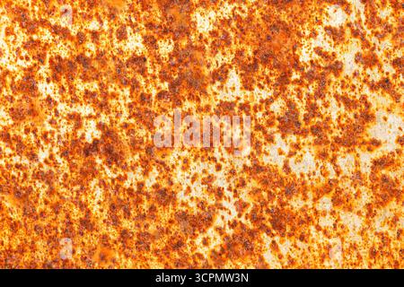 Rusty corroded metal surface. Abstract background with orange and red texture. Industrial material detail. Rough steel corrosion. Old metallic pattern. Stock Photo