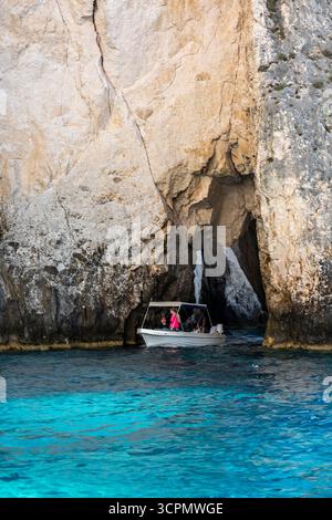 small tourists hired or rented boat exploring the caves and cliffs at Keri on the Greek Ionian Island of Zante or Zakynthos in Greece Stock Photo