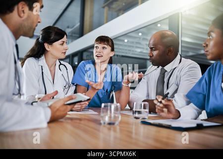Conversation, meeting and team of doctors in hospital with planning for medical treatment in collaboration. Nurses, discussion and group of healthcare Stock Photo