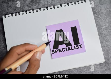 Concept of AI specialist write on sticky notes isolated on Wooden Table. Stock Photo