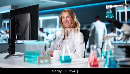 Female Scientist And Entrepreneur Professional Portrait With Computer Stock Photo