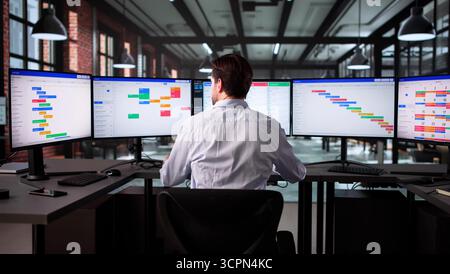 Senior Business Analyst Using Scrum Software To Manage Office Tasks Stock Photo