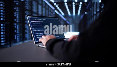 Man In Mask Hacking Server For Identity Theft And Scam. Stock Photo