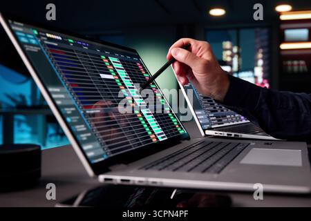 Senior Accountant Analyzing Tax Data On Business Laptop At Night Stock Photo