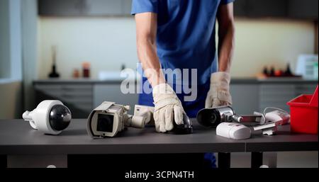 Senior Technician Installing Surveillance Camera For Building Security System Stock Photo