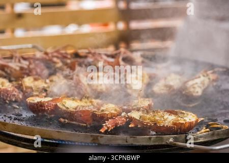 Close-up of grilled fresh spiny lobsters served at the traditional Lobster Festival in A Guarda, Galicia, Spain. Local seafood celebration on the Atla Stock Photo