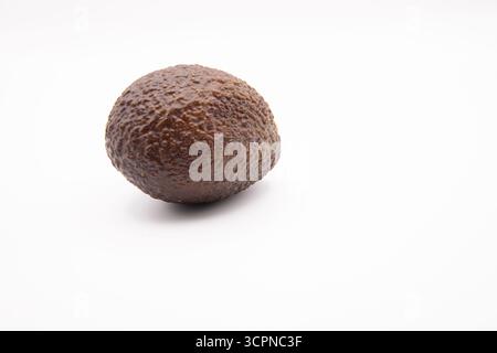 Close-up of a fresh ripe avocado fruit, whole and isolated against a clean white background. Stock Photo