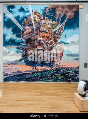 Woven adventures in the exhibition rooms of the Cité internationale de la tapisserie Aubusson. Here, 'The moving castle at sunset' from the 2004 anime film Howl's Moving Castle. Woven in Aubusson from March 2022 to February 2023. Rue Williams Dumazet, Aubusson, Nouvelle-Aquitaine, France Stock Photo