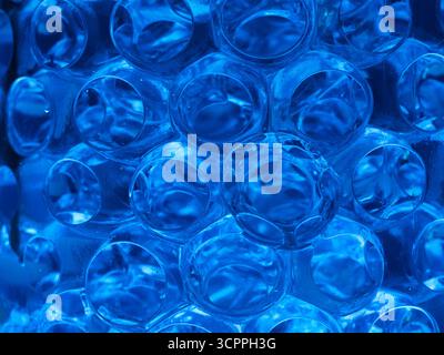 Abstract Blue Balls Water Texture Pattern - Close-up macro shot of transparent blue spheres, creating a fascinating liquid or futuristic texture. Idea Stock Photo