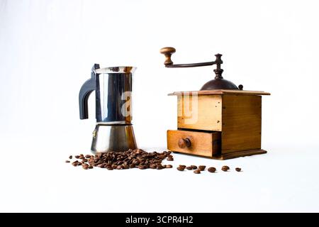 vintage coffee mill and moka coffee maker with coffee beans on white background Stock Photo