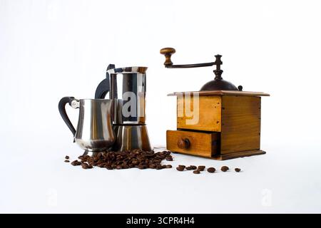 vintage coffee mill, moka coffee maker and metal jug with coffee beans on white background Stock Photo