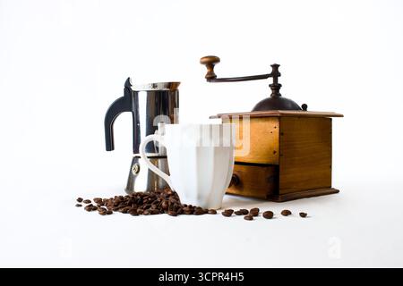 vintage coffee mill, moka coffee maker and white mug with coffee beans on white background Stock Photo