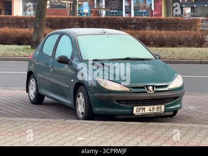Ostrava, Czechia - March 4, 2025: Green Peugeot 206 hatchback car parked on street in frozen morning Stock Photo