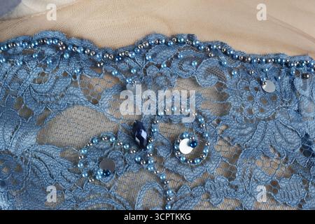 Textured and patterned background. Green brocade. Floral embroidery adorned with pearl beads. Stock Photo
