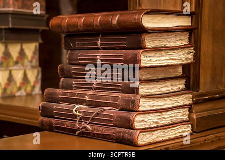 Kolomna, Russia - August 17, 2014 - Stack of vintage leather-bound journals with aged pages. Stock Photo