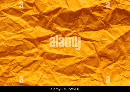 Crumpled Orange Paper Texture with Dimensional Folded Surface Stock Photo