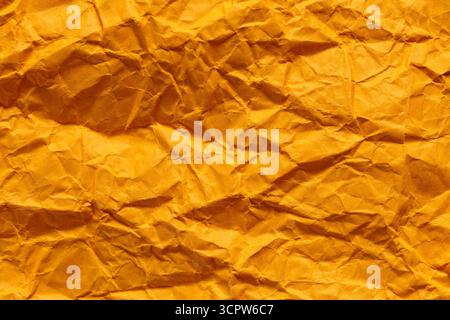 Crumpled Orange Paper Texture with Dimensional Folded Surface Stock Photo