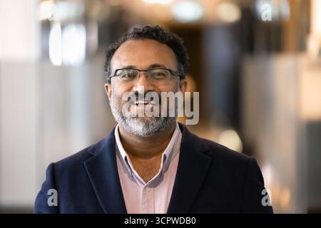 Head shot portrait of older Indian businessman posing for camera Stock Photo