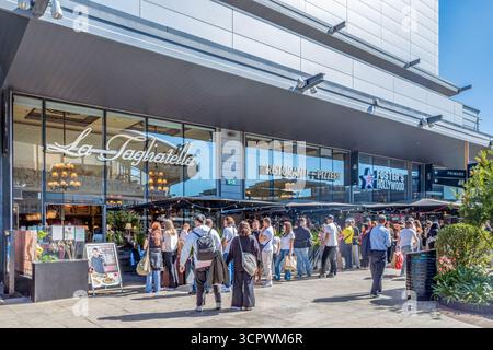 Long Queue Forms At Popular, in Spain, La Tagliatella Italian Restaurant Chain During Peak Hours At Shopping Mall. Food Service, Editorial Use Stock Photo