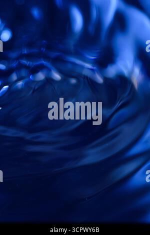 294.Dynamic Dark Blue Fluid Motion.An abstract, intense close-up of a dark blue fluid surface. The swirling motion creates a dynamic visual texture wi Stock Photo