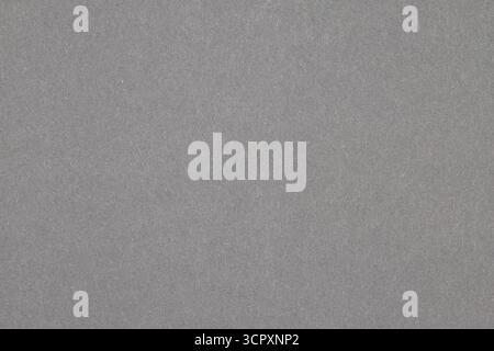 The image shows a uniformly textured, gray surface, likely paper or fabric, filling the entire frame. Stock Photo