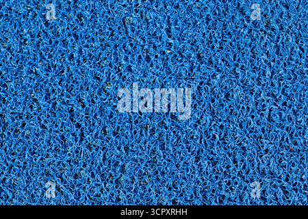 Close-up of a blue, densely packed, looped-pile mat. The texture fills the entire frame. Stock Photo