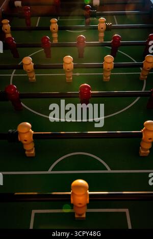 Red and yellow soccer players and table football figures on a foosball game Stock Photo