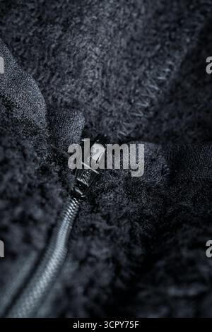 Zipper on black fabric with metal inserts and blue teeth Stock Photo