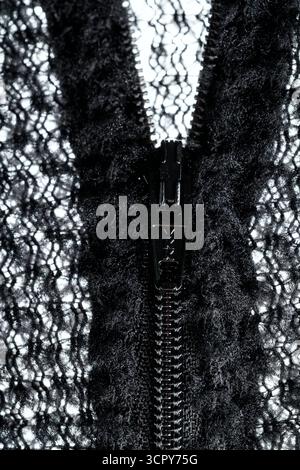 Zipper on black fabric with metal inserts and blue teeth Stock Photo