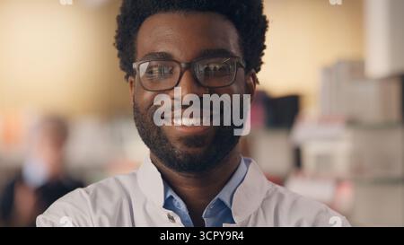 Happy doctor African American man smiling health insurance medicine pharmacy professional medical checkup physician healthy therapy clinic male Stock Photo