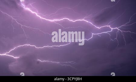 Unreal cloud-to-cloud lightning bolts with intricate branching illuminating storm clouds at night — dramatic thunderstorm sky Stock Photo