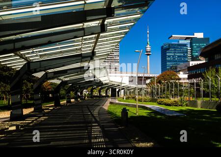 Modern Vienna cityscape featuring Donauturm and Austria Center with geometric glass structures and vivid sunlight Stock Photo