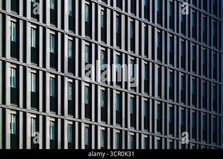 Modern residential building facade with repeating balconies and geometric grid pattern in contemporary architectural design Stock Photo