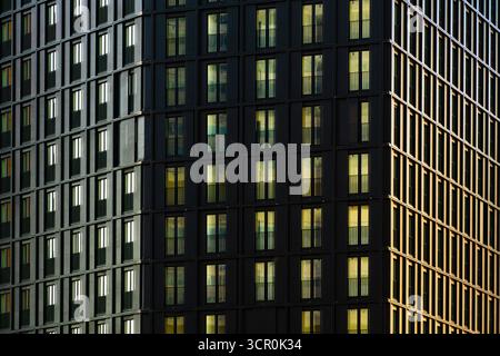 Modern residential building facade with repeating balconies and geometric grid pattern in contemporary architectural design Stock Photo