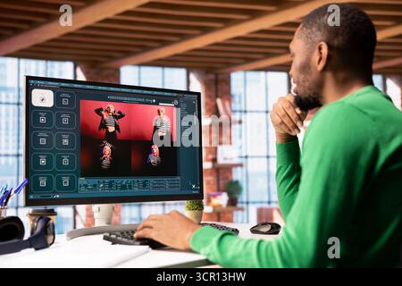 Man in apartment workspace using AI software on computer turning text prompt into photos. Person in brick wall home office uses text to image generative models on PC monitor Stock Photo