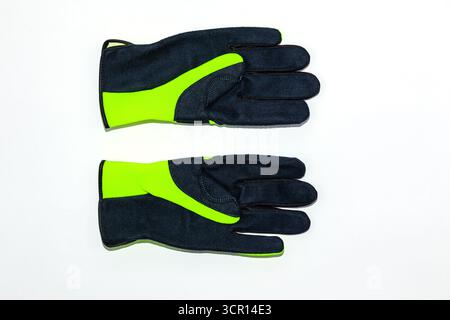 Protective work gloves on a white background, green - black with black leather and green synthetic material. Stock Photo