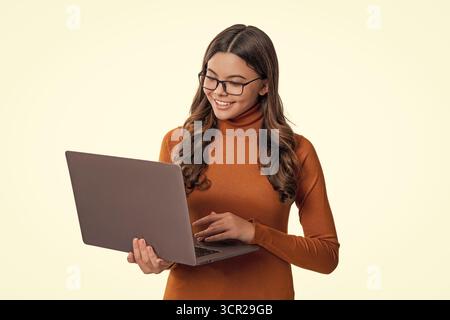Teen girl study online isolated on white. Online education. Back to school. Girl in eye protecting glasses using laptop. School education online. Teen Stock Photo