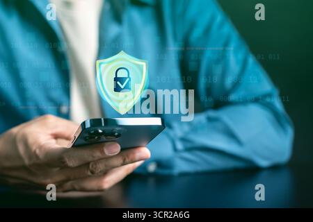 Cybersecurity and mobile data protection concept. Smartphone with digital shield and lock, online Stock Photo